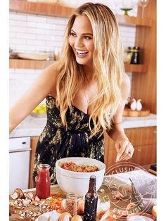 a woman standing in front of a bowl of food