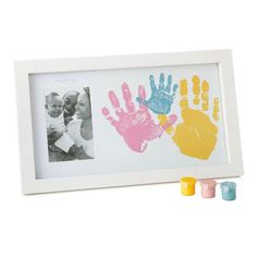 two handprints are shown in front of an empty white frame