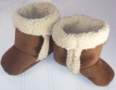 a pair of brown and white baby boots