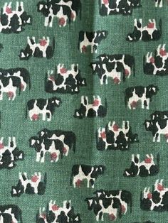 a green and black cow pattern with red spots on it's back ground,