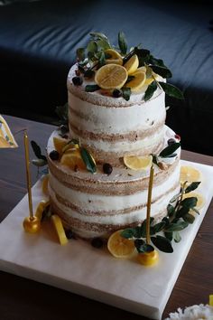 a three tiered cake with lemons on top