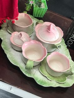 pink and green dishes sit on a tray