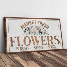 a sign that says market fresh flowers blooms stems seeds