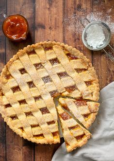 an italian jam tart is cut into slices and placed on a wooden table with the text, classic chostata italian jam tart