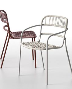 two chairs sitting next to each other on a white surface