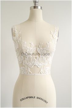 a white dress on a mannequin with the words couture lace in black