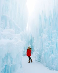 a woman standing in front of ice formations