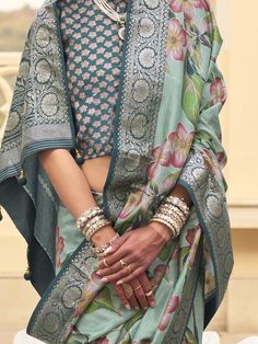 This stunning mint green floral printed silk saree with blouse is the perfect choice for weddings, festivals, and other special occasions. Its vibrant color and intricate print work make it a standout choice for anyone looking to make a statement. The zari weaving work adds an extra touch of elegance and luxury to the saree, making it a must-have in your ethnic wear collection.
The 5.50 meters of saree material and unstitched blouse material give you plenty of fabric to work with, allowing you t Bohemian Wedding Blouse With Zari Weaving, Traditional Floral Print Choli, Designer Green Tussar Silk Sets, Green Lehenga With Floral Print And Traditional Drape, Green Floral Print Lehenga With Traditional Drape, Traditional Green Floral Print Lehenga, Green Floral Print Choli For Navratri, Green Pre-draped Saree With Printed Motifs For Diwali, Green Pre-draped Saree With Floral Print