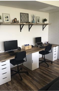 an office with two desks and three computer monitors