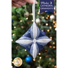 a blue ornament hanging from the side of a christmas tree