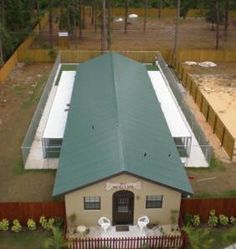 an aerial view of a house with a green roof