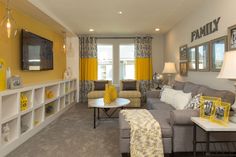 a living room filled with furniture and yellow curtains