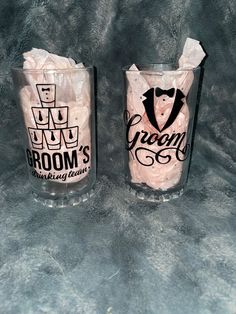 two shot glasses decorated with grooms and bride's names