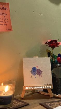 a candle and some cards on a table