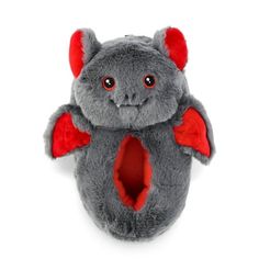 a gray stuffed animal with red wings on it's chest and eyes open, sitting in front of a white background