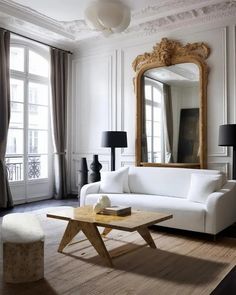 a living room filled with furniture and a large mirror