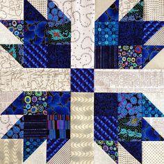 a blue and white quilt with many different designs on it