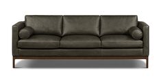 a brown leather couch sitting on top of a wooden frame