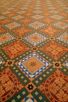 the floor is covered with colorful tiles and patterns