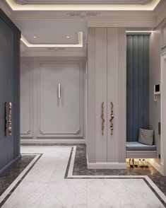 an elegant hallway with white walls and grey doors, marble flooring and gold accents