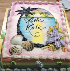 there is a cake with shells and flowers on it