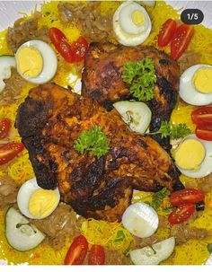 two pieces of chicken with boiled eggs and vegetables on a yellow platter filled with rice