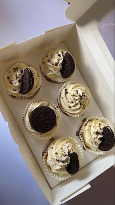 six cupcakes with oreo cookies and cream frosting in a white box