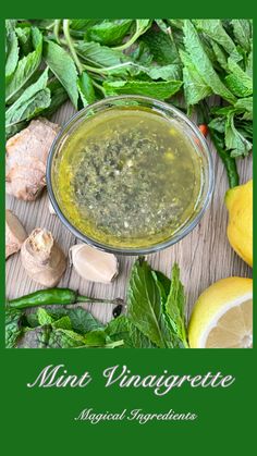 the ingredients for mint vinaigrette in a bowl on a table with lemons and