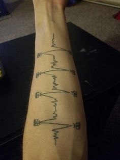 a man's arm with an electrical circuit tattoo on the left side of his arm