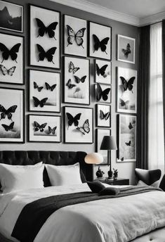 black and white bedroom with butterfly pictures on the wall above the bed, along with an upholstered headboard