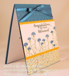 a greeting card with blue flowers and a bow on the front, says congratulations to your retirement