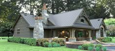 a large log home with a stone chimney