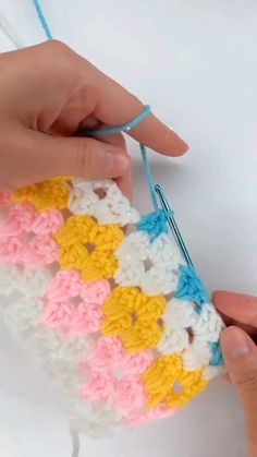 someone is crocheting an object with yarn