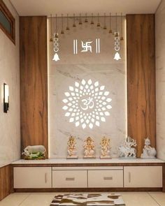 a living room with white walls and wooden paneling on the wall is decorated with buddha statues