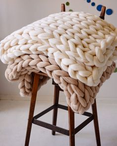 a chair that has some kind of blanket on it