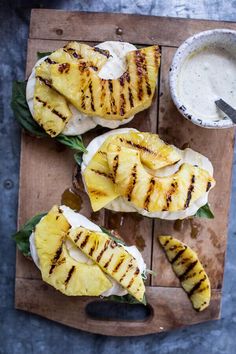 grilled pineapples with cream sauce on a cutting board