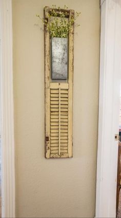 an old window with shutters is hung on the wall in a hallway next to a door