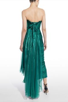 The breathtaking LUISE dress features a boned bodice and an asymmetrically draped silhouette. Crafted from precious metallic silk mousseline, Luise has an alluring lace-up back which ensures the perfect fit. The skirt follows the bodyline revealing a high slit under the draped panel which elegantly falls on the side
#eveningwear #fashion #style #prom #bridal #formalwear #redcarpet #sweet16 #model   #gowns #weddings #bridesmaids #prom2022 #sweetsixteen #homecoming #quinceanera #bridesmaids Themed Prom Dresses, Feather Prom Dress, Strapless Evening Dress, Womens Prom Dresses, Teal Dress, Pleated Fabric, Basic Dress, Glam Dresses, Dresses Evening