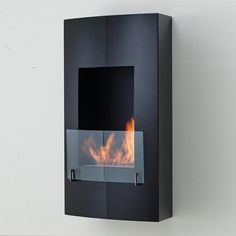 a black wall mounted fireplace with flames in it