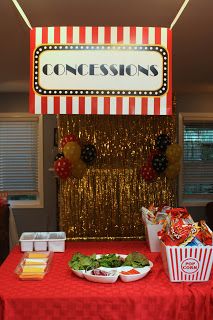 a red and white table topped with food next to a sign that says concessions