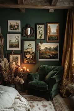 a bedroom with green walls and pictures on the wall, candles in front of it