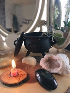 a candle and some rocks on a table