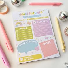 a daily planner surrounded by office supplies