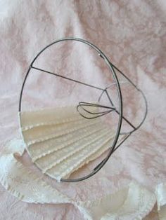 a metal object sitting on top of a white cloth covered tablecloth with circles and lines