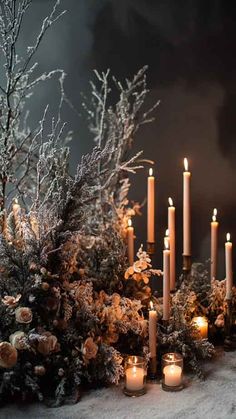 a bunch of candles that are sitting in the snow