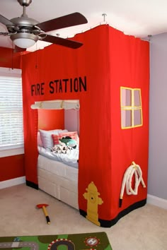 a bedroom with a fire station tent bed