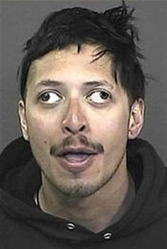 a man in a black hoodie is making a face with his eyes wide open