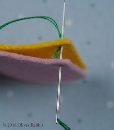 the needle is being used to sew on some material that has been stitched together