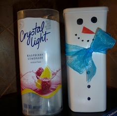 two frosty cups decorated like snowmen and one with a blue bow on it