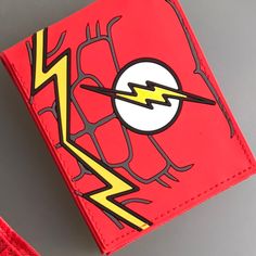 a red wallet with the flash logo on it and lightning bolt drawn across the front